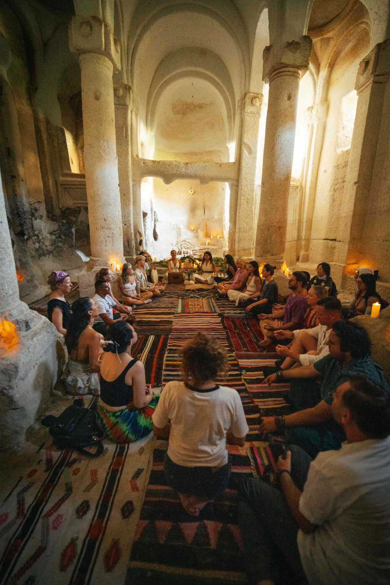 A sound circle in a candlelit rock-carved church