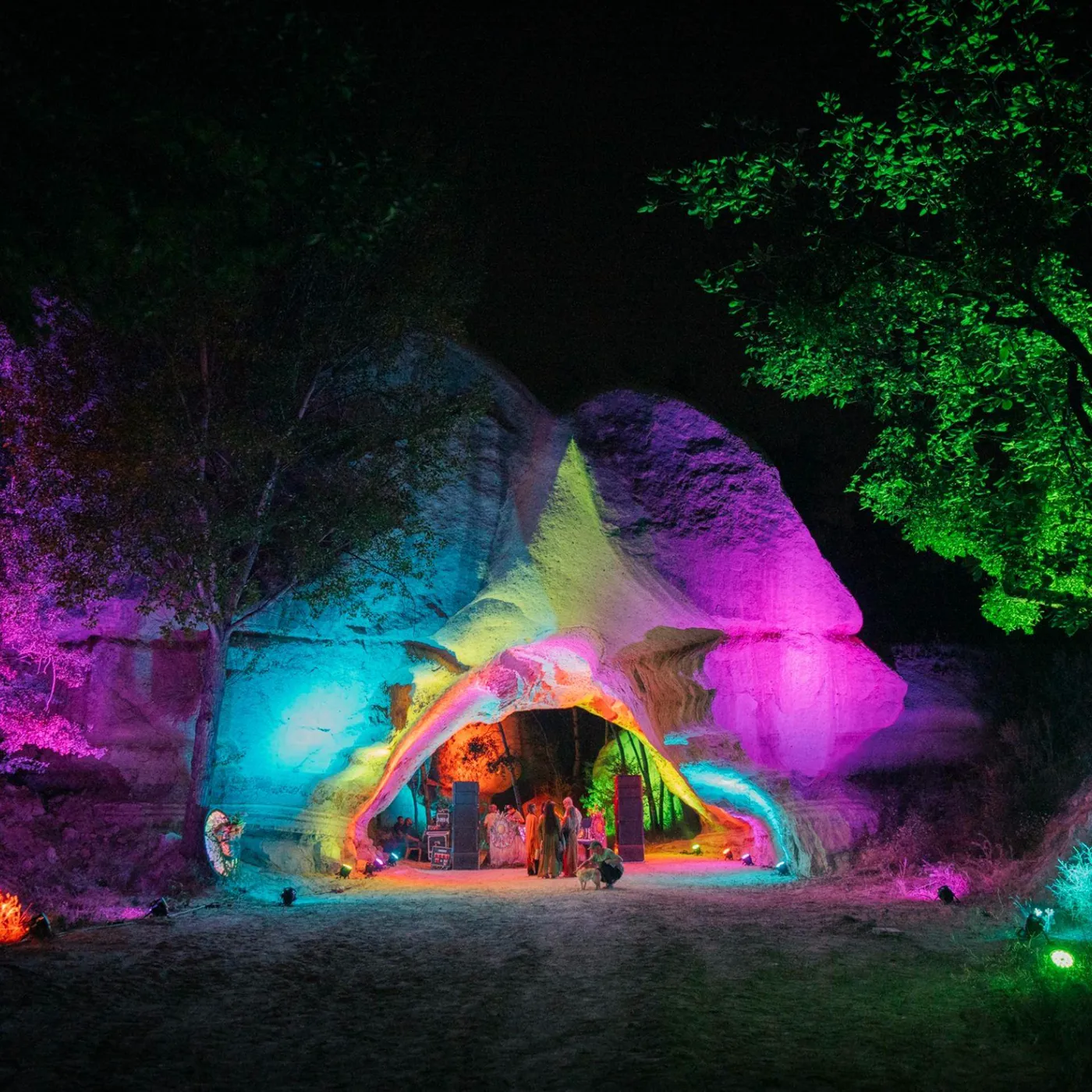 A rock cave lit in colour for a night concert