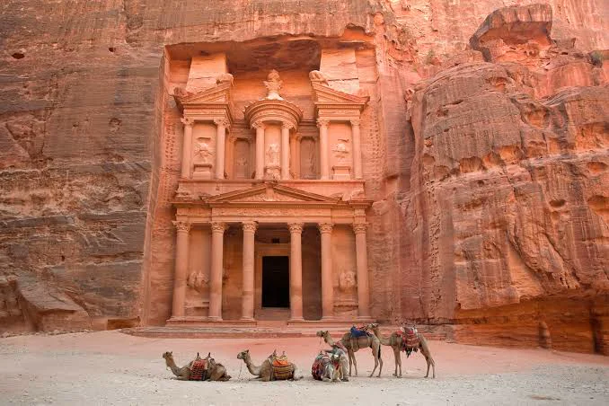 The Treasury in Petra, Jordan, with camels resting in front